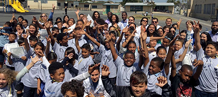 UC Irvine Doctors for Diversity group cheers with Long Beach elementary school students who completed a medical education awareness course.