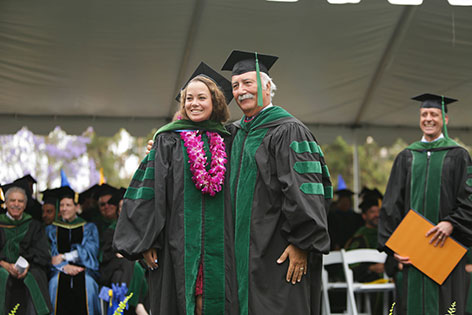 Brianna Miner, UC Irvine School of Medicine Class of 2017 graduate, receives her ceremonial hood from Dr. Mauel Porto.