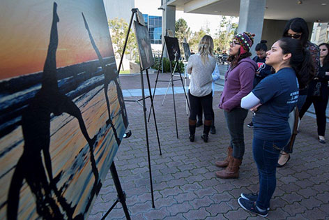 UC Irvine medical students attend an exhibit of fellow students' art work, created as part of the School of Medicine's effort to incorporate the humanities and arts into its programs.
